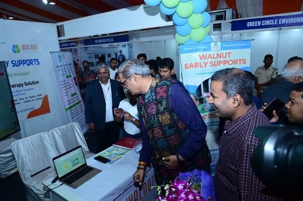Deputy Chief Minister exploring Walnut Early Supports materials on screen